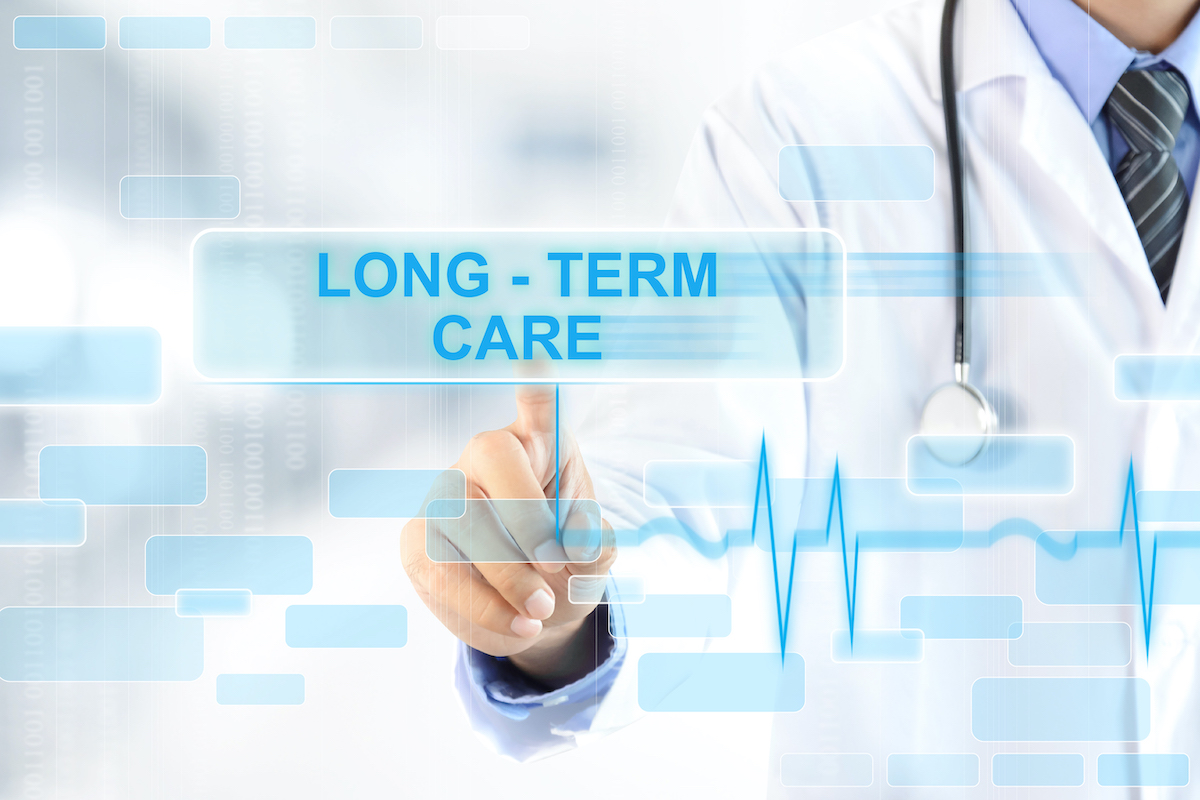 Doctor touching LONG – TERM CARE sign on virtual screen